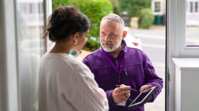 Friendly local service tech from giggle fiber meeting with a customer at their home